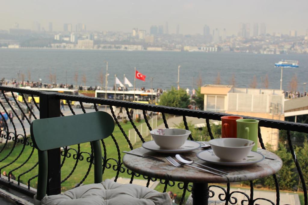 a table with two coffee cups on top of a balcony at Suit Üsküdar in Istanbul