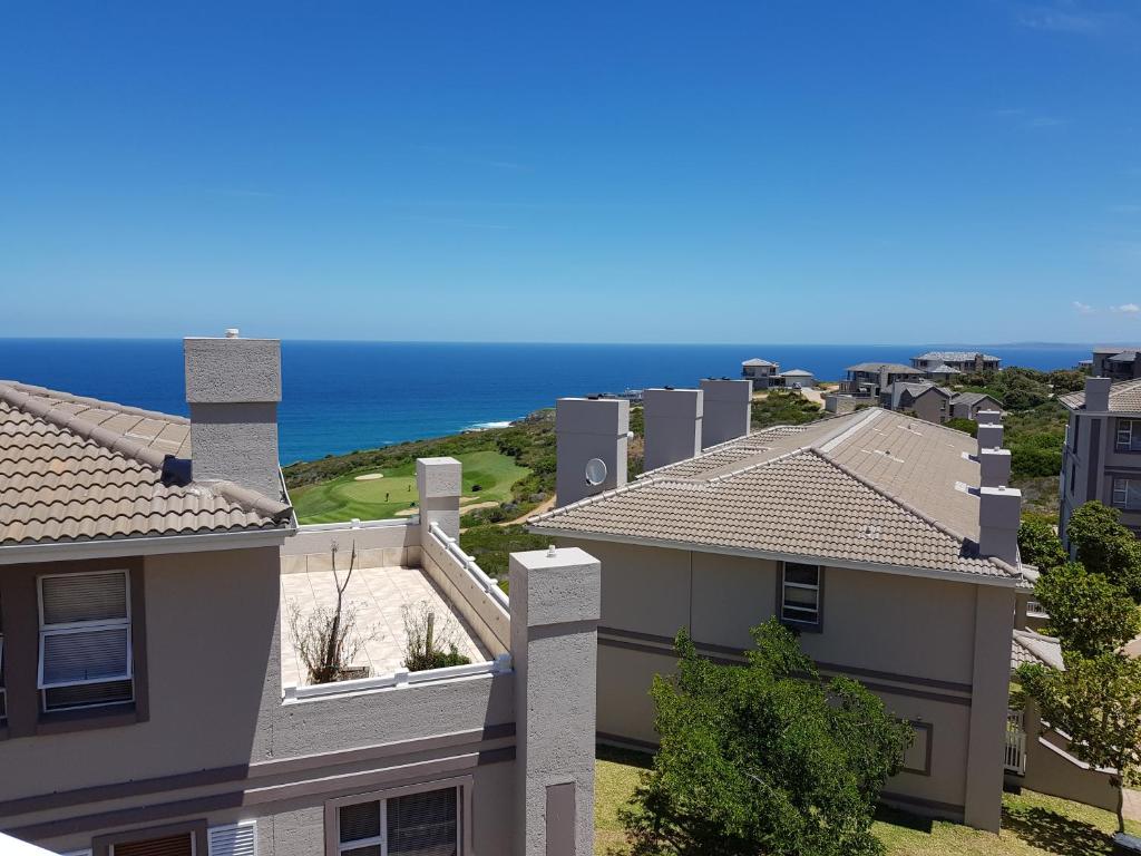 an aerial view of a house with the ocean in the background at Luxury Villa in Pinnacle Point with Inverter in Mossel Bay
