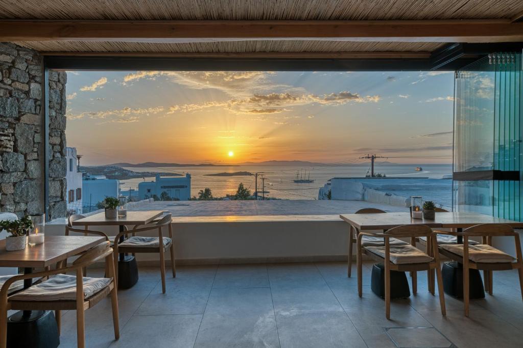 un restaurante con vistas a la puesta de sol en Damianos Mykonos Hotel en Mykonos