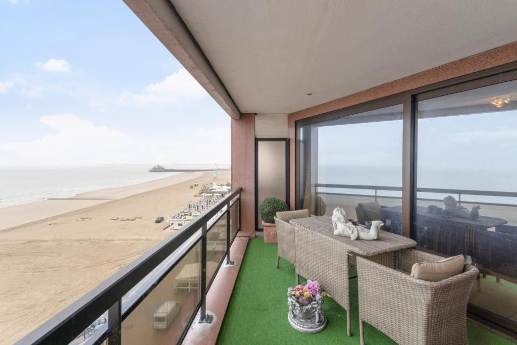 a balcony with a view of the beach at seaview apartment margo in Blankenberge