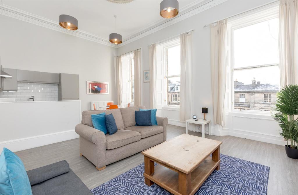 a living room with a couch and a table at Southside Apartments by Destination Edinburgh in Edinburgh