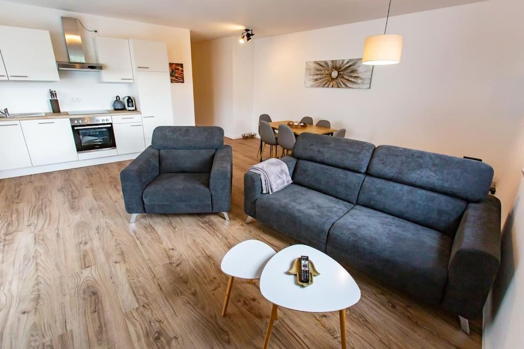 a living room with a couch and two chairs and a table at Große COZY 4-Zi-Whg mit Balkon Nähe Europa Park und Rulantica in Lahr