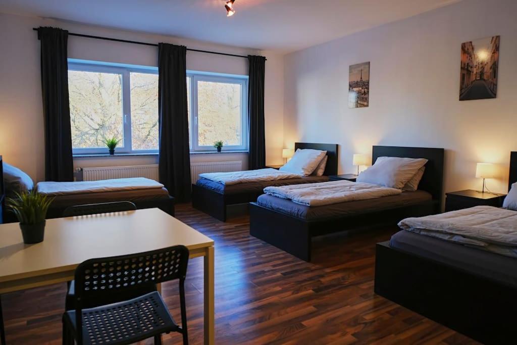 a living room with two beds and a table at Schöne 4-Bettzimmer Wohnung in Celle in Celle