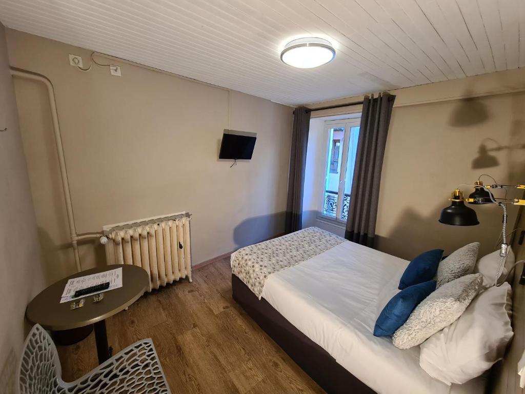 Postel nebo postele na pokoji v ubytování Le Grand Hotel