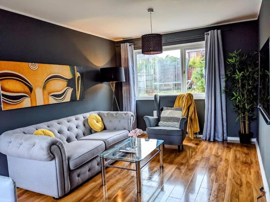 a living room with a couch and a table at Hidden Gem !Stunning 3 bedroom home in Sheffield in Handsworth