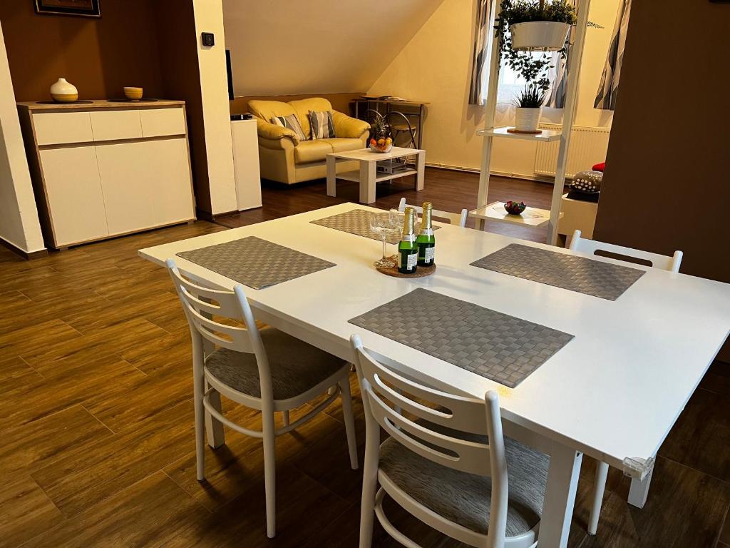 a white table and chairs in a living room at Apartmán Frank in Česká Kamenice