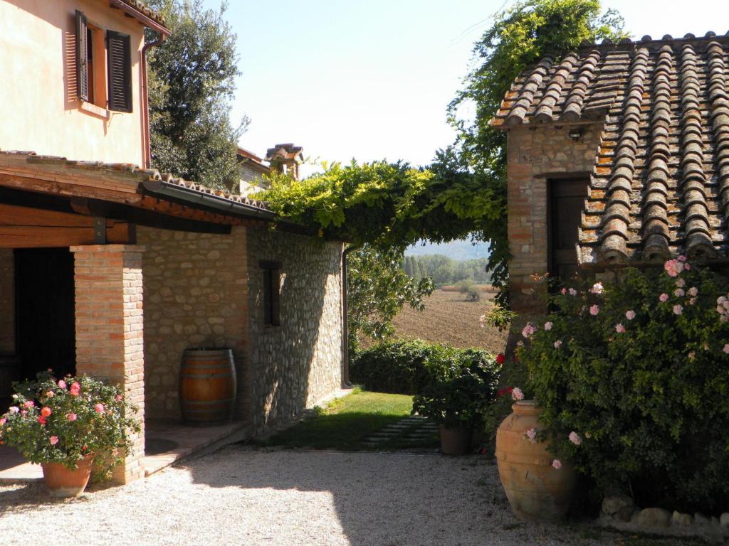 an external view of a building with flowers in pots at Agriturismo Borgo Laurice in Torgiano