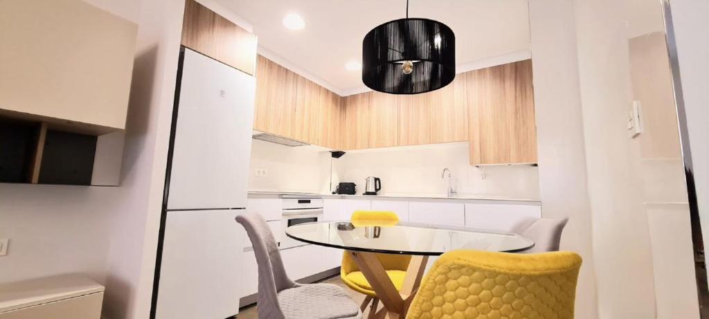 a small white kitchen with a table and chairs at PISO EN DURANGO in Durango