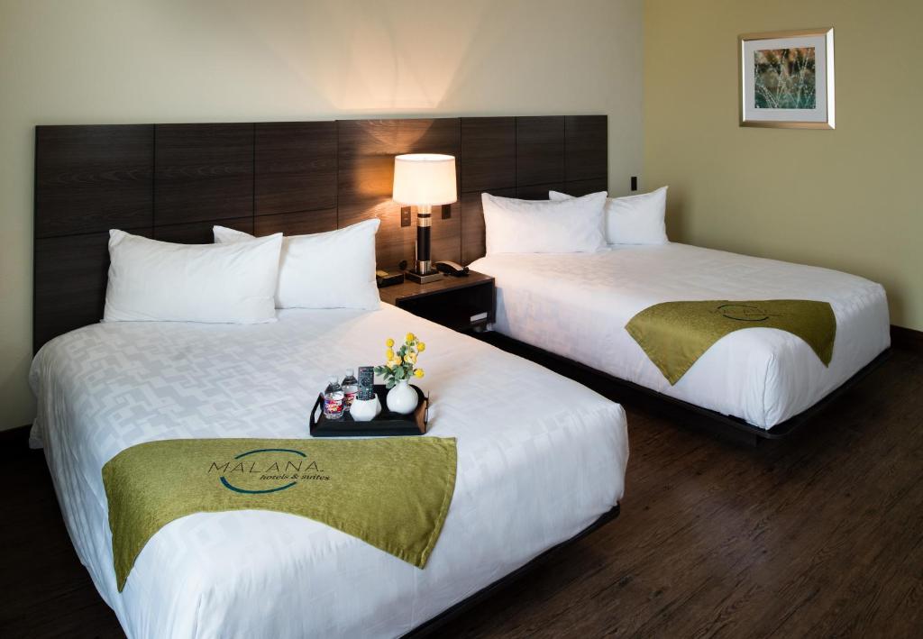 Postel nebo postele na pokoji v ubytování Malana Hotels & Suites