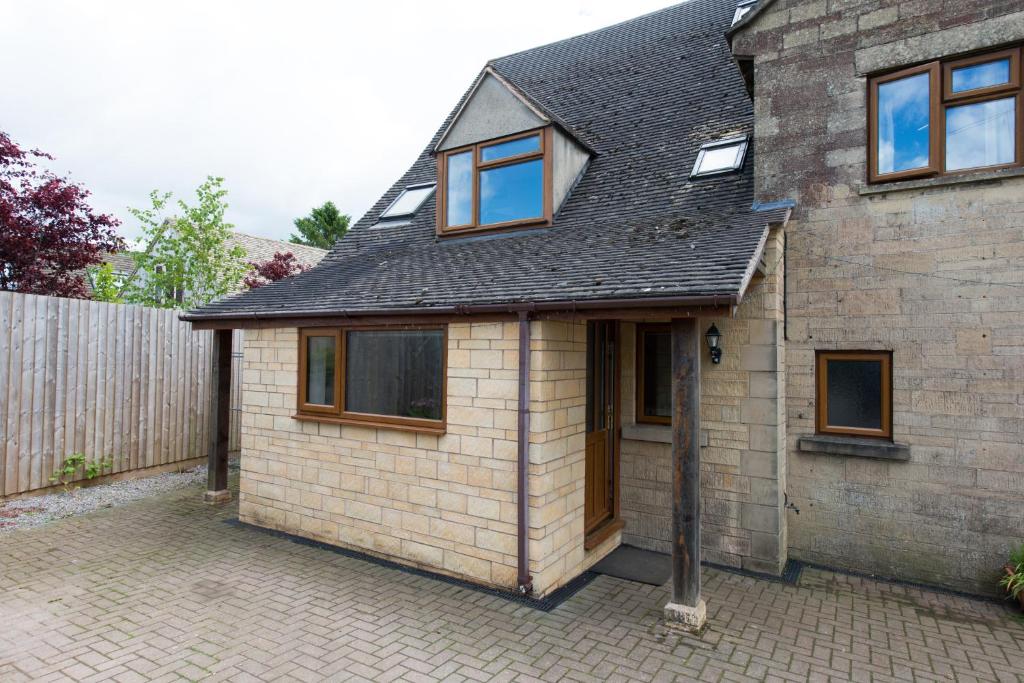 a small brick house with a driveway at Blacklaines Annexe in Gloucester