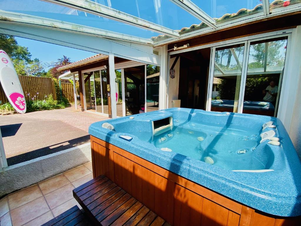a hot tub sitting outside of a house at Villa Patio + jacuzzi, FREE Surf+Body+Sup in Capbreton