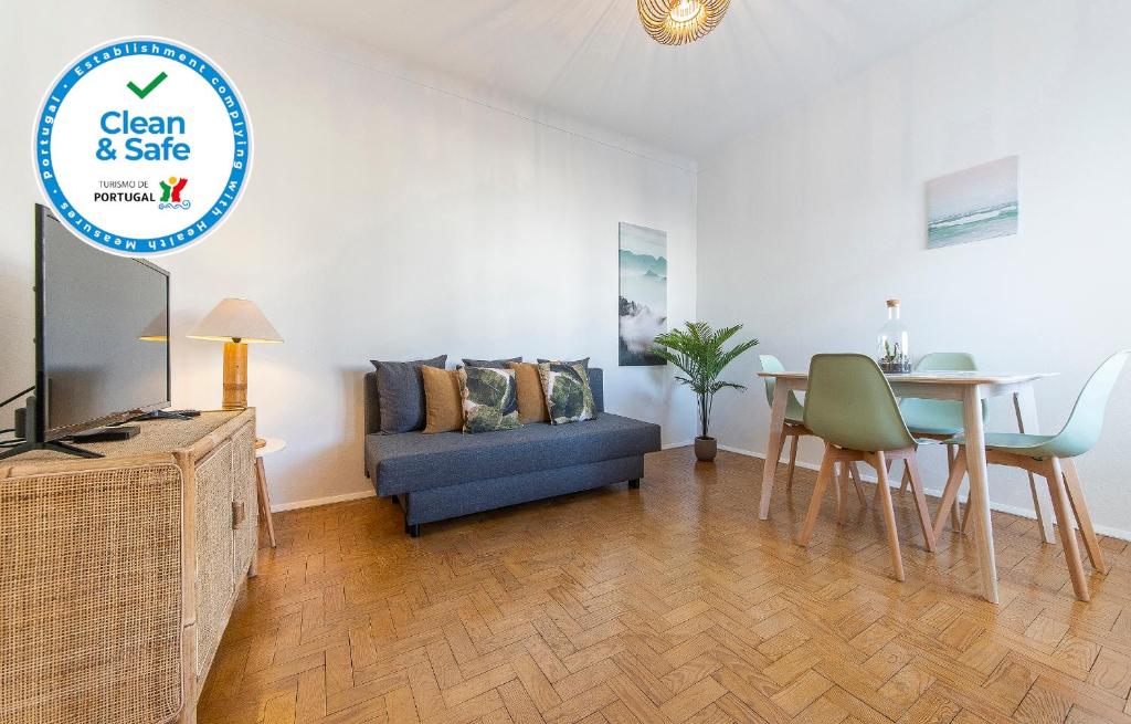 a living room with a blue couch and a table at Abrotea Apartments in Lagos