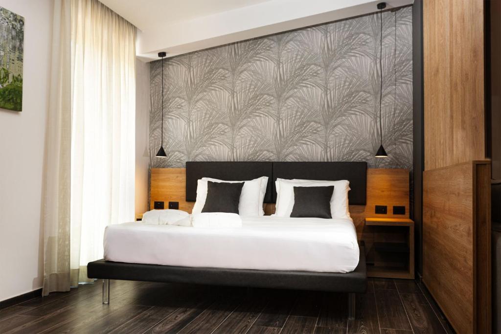 Łóżko lub łóżka w pokoju w obiekcie Donna Vì Hotel