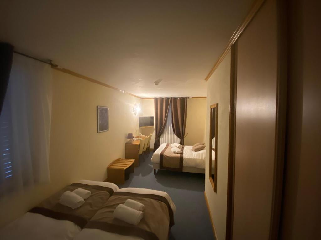 Postel nebo postele na pokoji v ubytování Logis Hôtel restaurant Bel Horizon