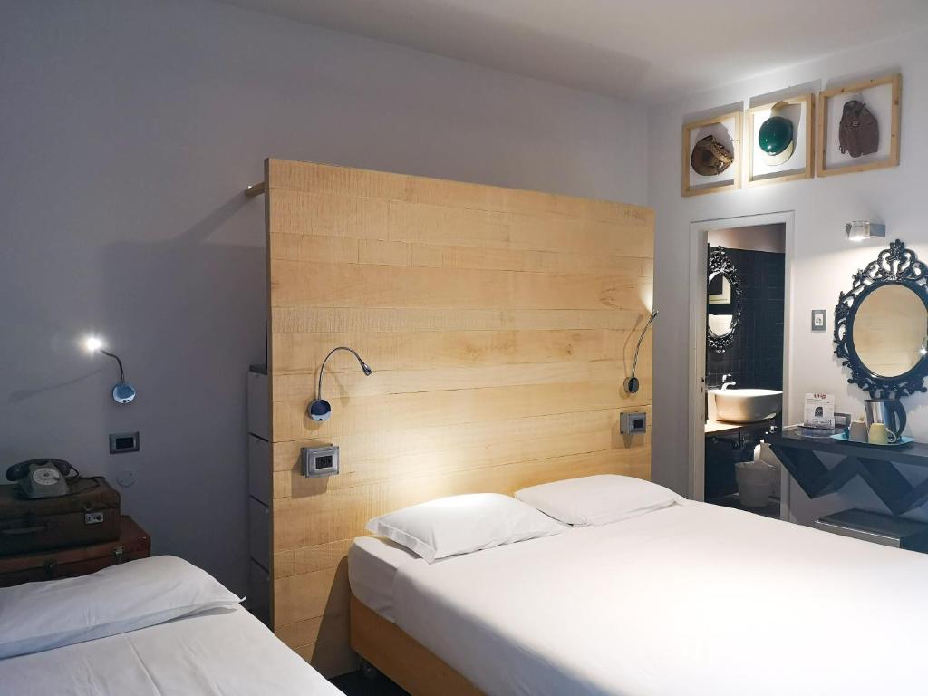 Postel nebo postele na pokoji v ubytování Hotel Perla - The storyhoteller