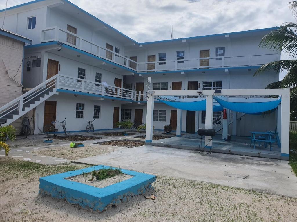 a large white building with a large courtyard at Rachel Land in Caye Caulker