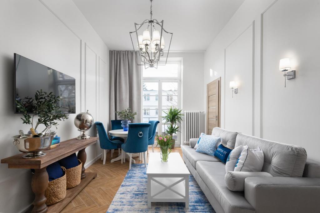 a living room with a couch and a table at Movo Old Town Apartments in Warsaw