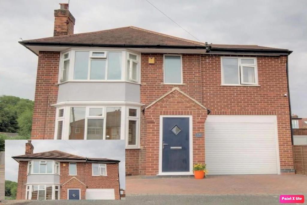 a red brick house with a white garage at Luxurious 4 Bedroom Detached Family Home in Burton Joyce