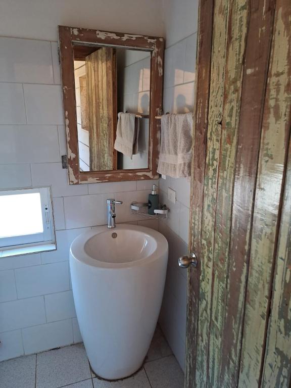 a bathroom with a sink and a mirror at Hostal Dos Volcanes in Malalcahuello