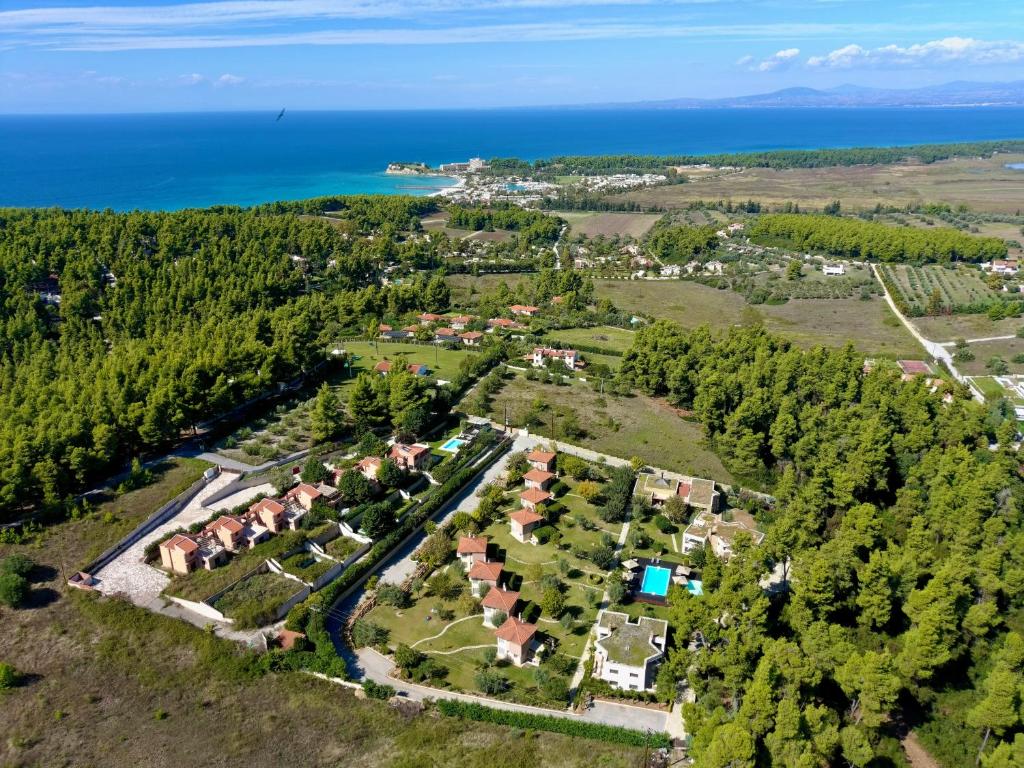 an aerial view of a village with houses and the ocean at Sani Polyastron Hotel & Spa in Sani Beach