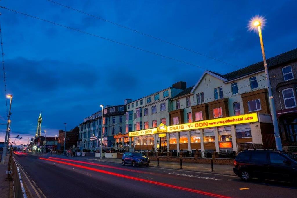 a street with cars driving down a street at night at Craig-y-Don in Blackpool