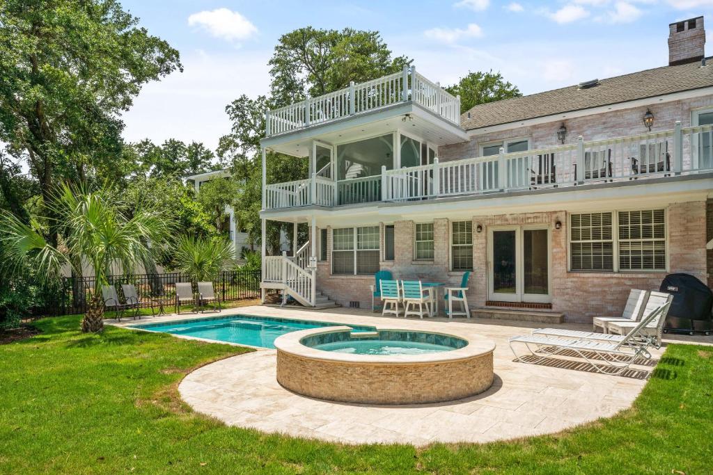a house with a swimming pool and a patio at 44 Dune House - 1901 Dixon Lane in Saint Simons Island
