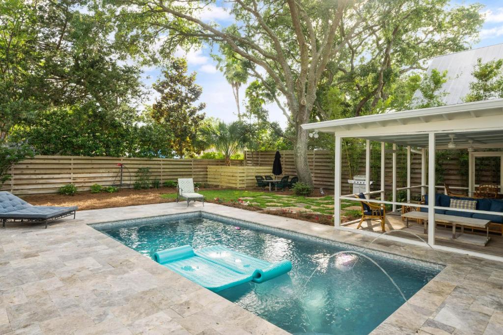 a swimming pool in a yard next to a house at Endless Summer - 4217 - 6th Street in Saint Simons Island