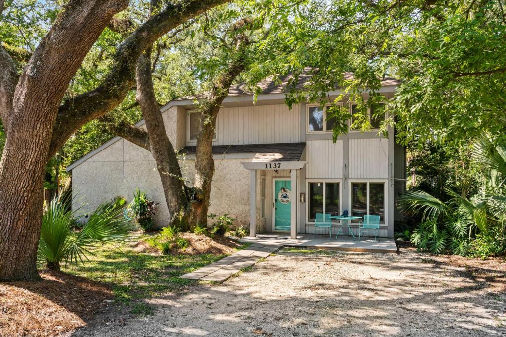 ein Haus mit einer grünen Tür und Bäumen in der Unterkunft Crab Haven - 1137 Park Lane in East End