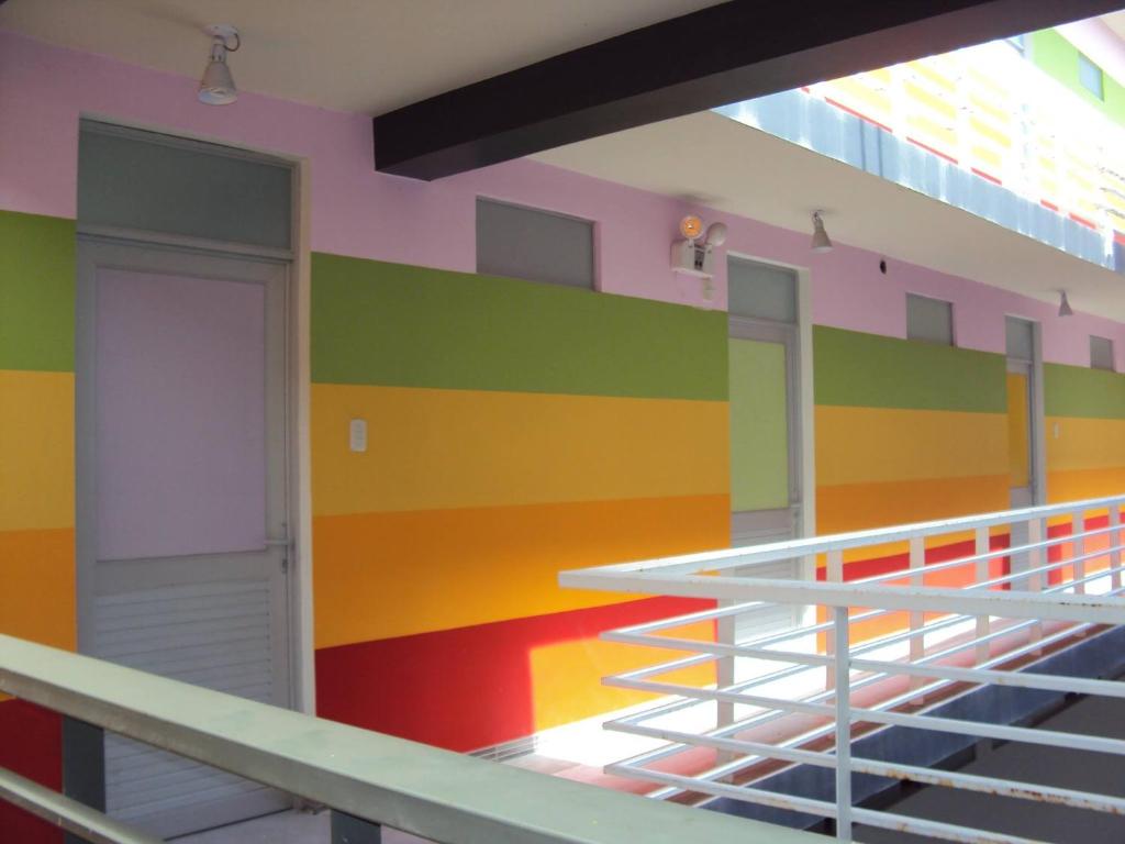 a brightly colored wall in a building with a staircase at Selva Suites in Iquitos