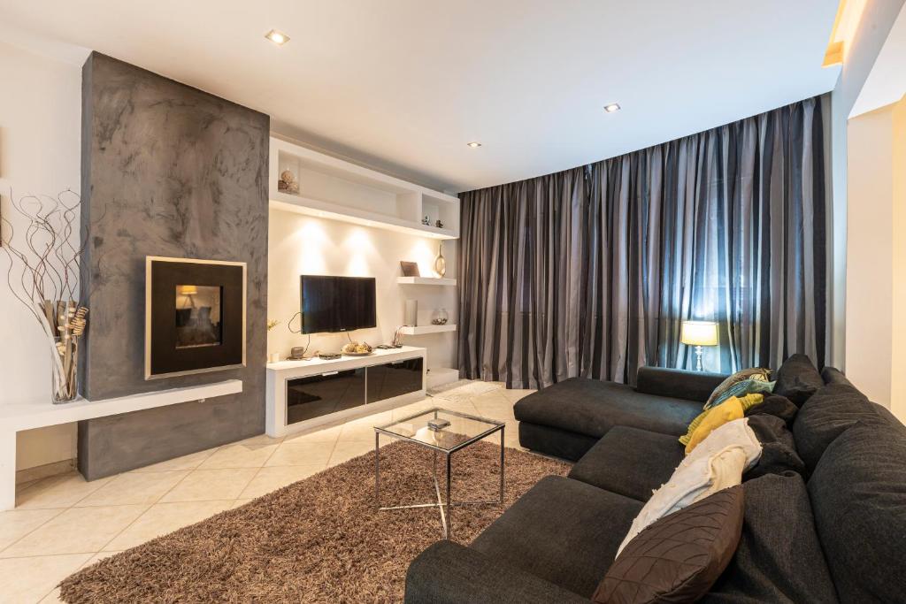 a living room with a couch and a tv at Spacious 3BR APT in Prime Location of St Julians by 360 Estates in Tal-Għoqod