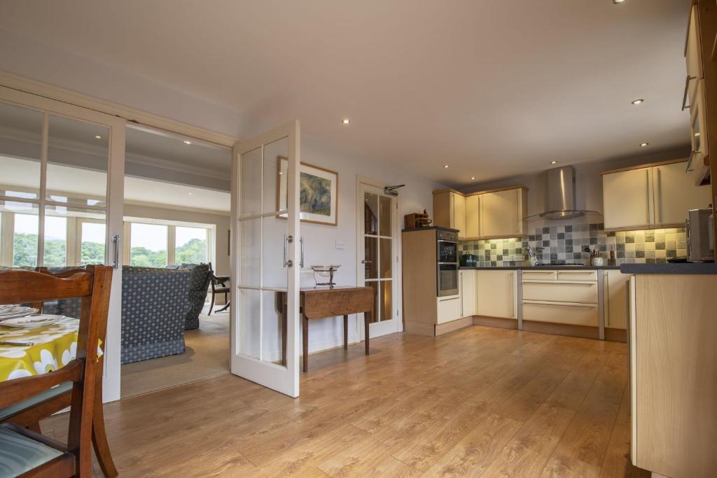 a large kitchen with wooden floors and a dining room at River View in Ingleton