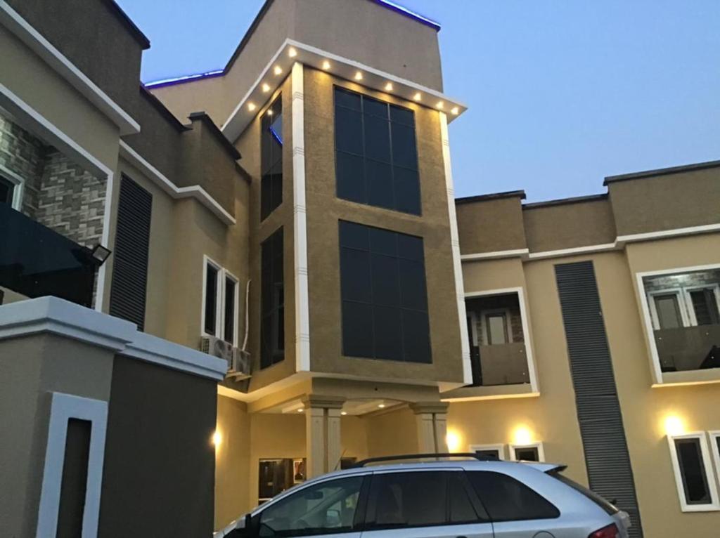 a car parked in front of a house at Clique Court Hotel & Suite in Opete