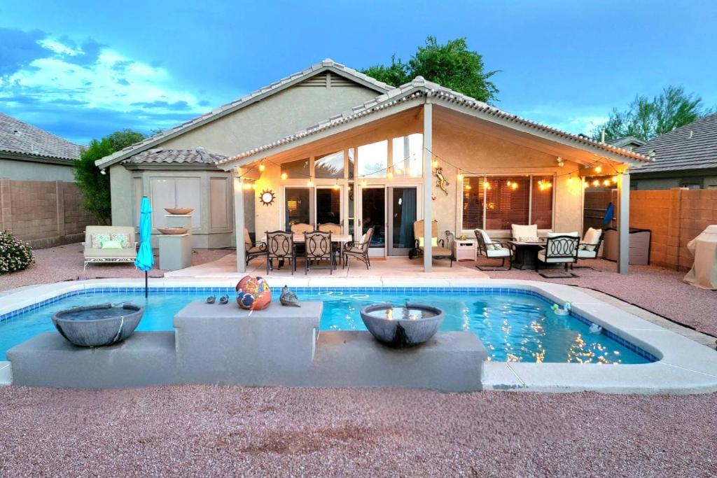 a swimming pool in front of a house at Honeysuckle Oasis in Gold Canyon