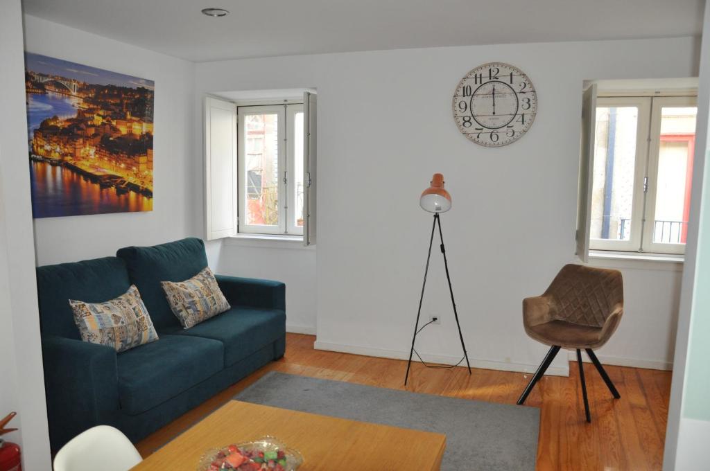 a living room with a blue couch and a table at Koka's Apartment in Porto