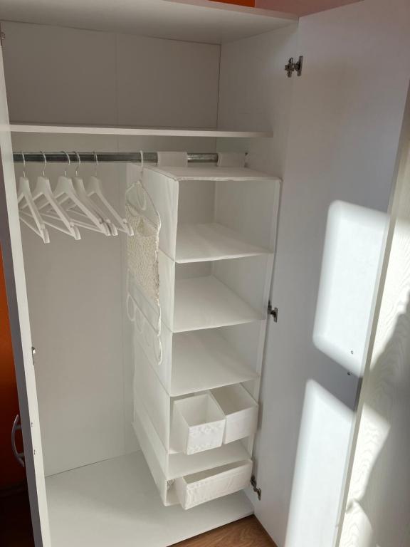 a white refrigerator with empty shelves in it at Altes Stadtgut am Bauhaus Museum in Weimar