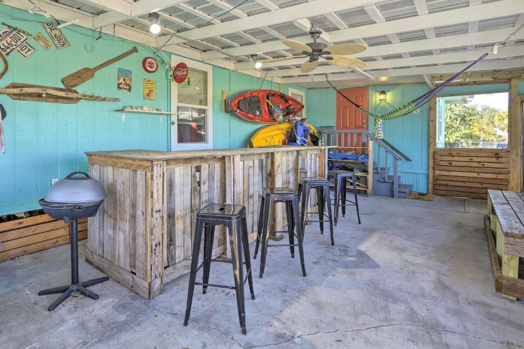 a bar in a room with stools at Pet-Friendly Cocoa Home with Covered Porch! in Cocoa