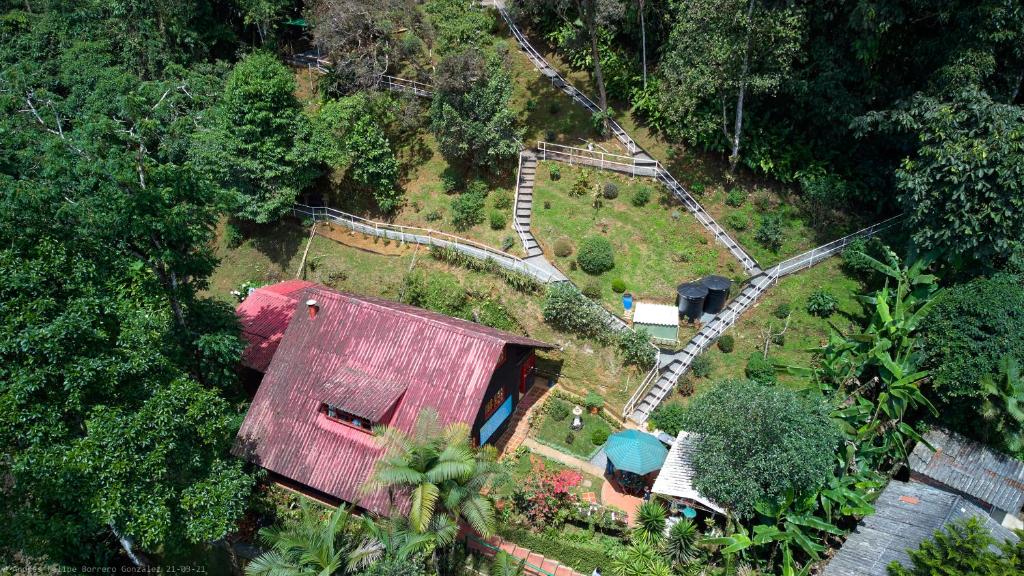 an aerial view of a house with a train yard at Bosque de Niebla Birding & Nature in Cali