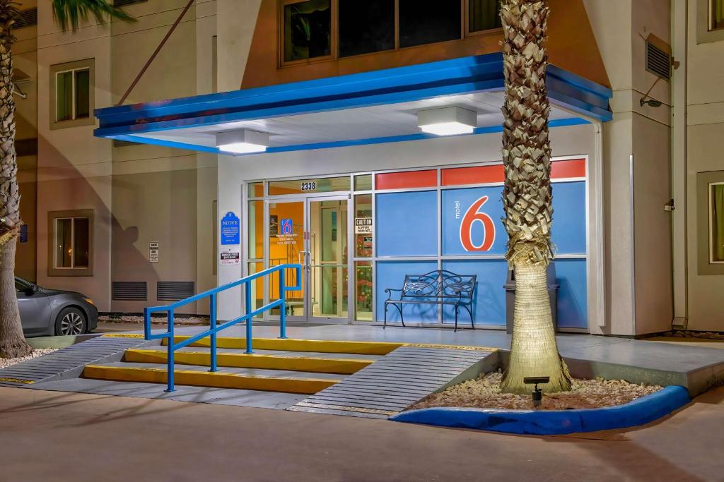 a gas station with a palm tree in front of it at Motel 6-Eagle Pass, TX - Lakeside in Eagle Pass