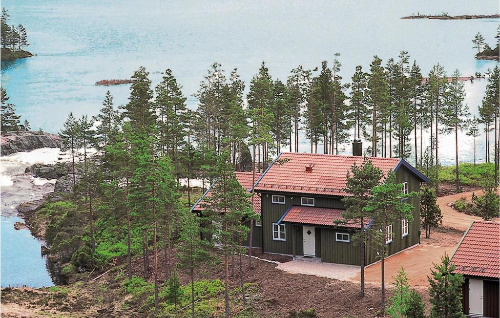 a house on a hill next to a body of water at Jervehiet - Hytte 4 in Øvre Ramse