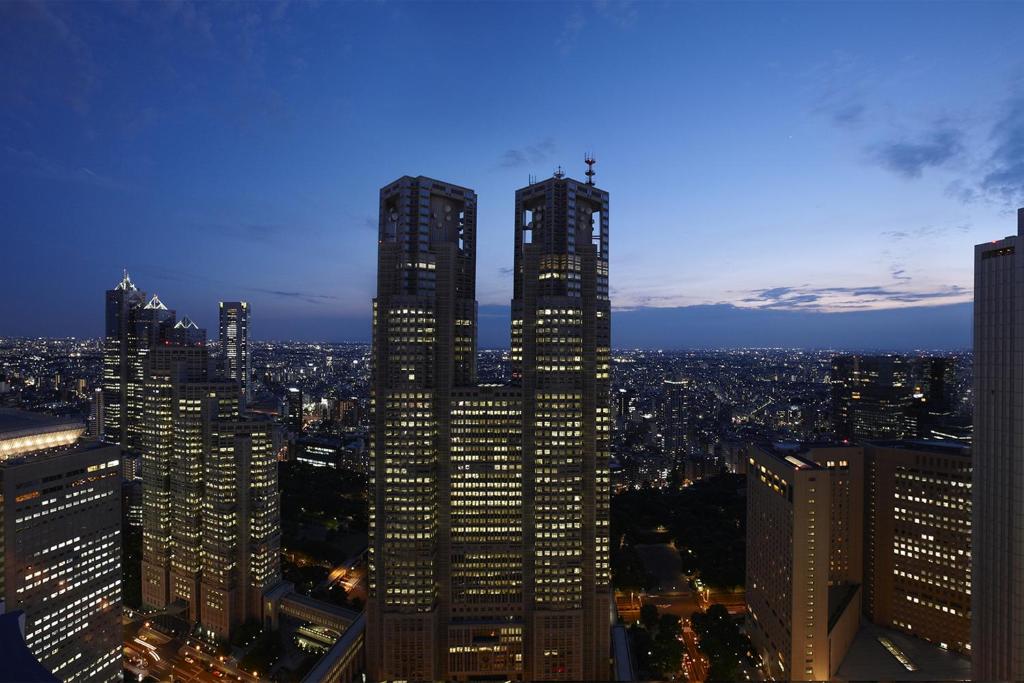 a view of a city at night with tall buildings at Keio Plaza Hotel Tokyo in Tokyo