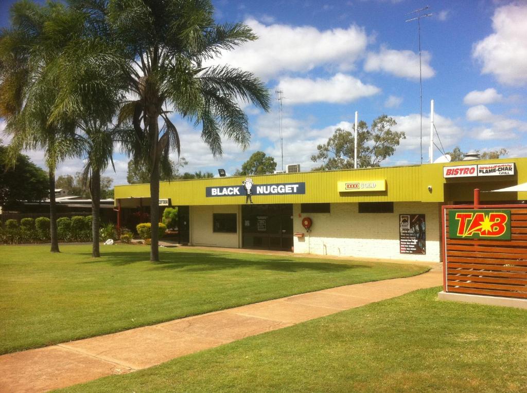 a large building with a sign on the side of it at Black Nugget Hotel Motel in Moranbah