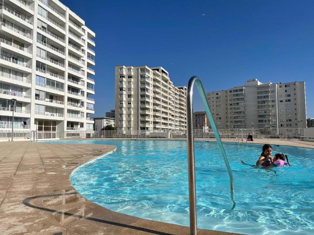 2 enfants dans une piscine avec des bâtiments en arrière-plan dans l'établissement Vista Pacifico, Serena, à La Serena