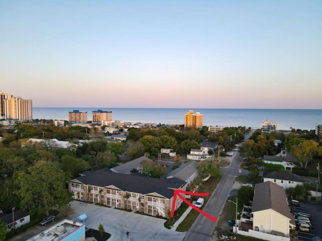 an aerial view of a city with a red arrow at Lovely 4BR King Beds Steps To Beach And Pier G in Myrtle Beach