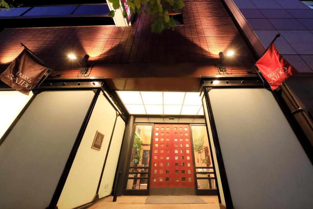 a pair of doors in front of a building at Hotel Nihonbashi Saibo in Tokyo