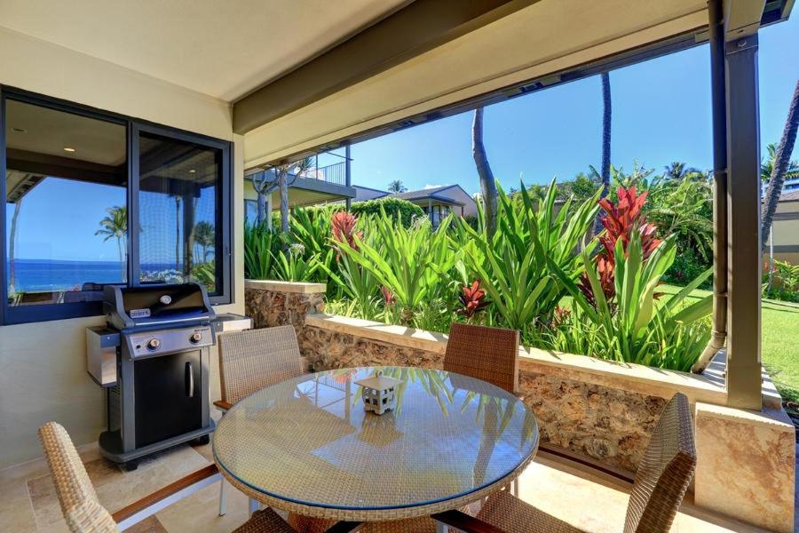 a dining room with a table and a stove at WAILEA ELUA, #1403 condo in Wailea