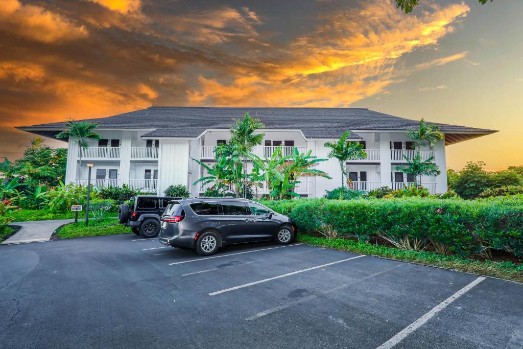 a car parked in a parking lot in front of a building at Kauai Kiahuna Plantation by Coldwell Banker Island Vacations in Koloa
