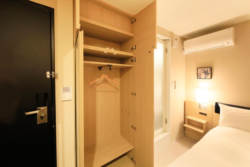 Postel nebo postele na pokoji v ubytování Hotel Nihonbashi Saibo