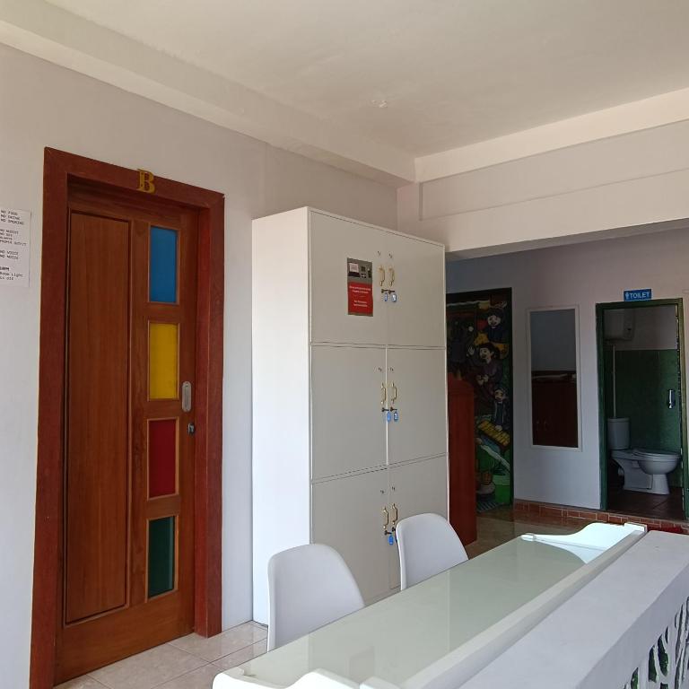 a room with a table and chairs and a door at BSH (Bu Sud's House) Yogyakarta in Yogyakarta