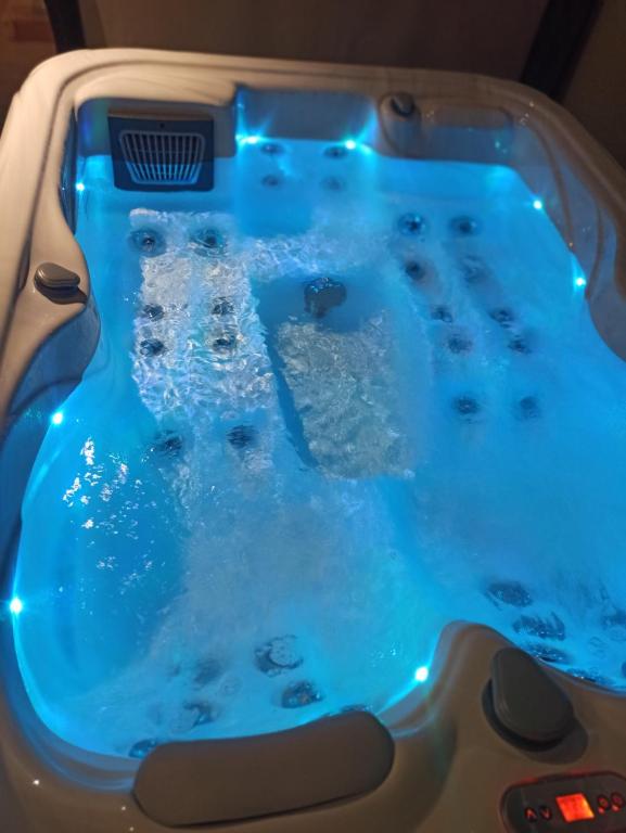 a jacuzzi tub with blue lights on it at Le clos marin in Blendecques
