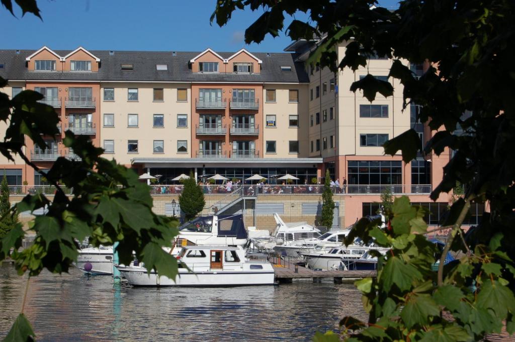 un gruppo di imbarcazioni ormeggiate in un porto turistico con edifici di Radisson Blu Hotel, Athlone a Athlone
